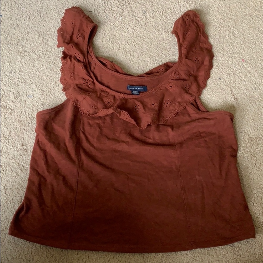 Sleeveless/tank top. Rust or port-colored.